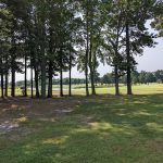 Panoramic view of a lush green golf course at The Hollows Golf Club. Smooth