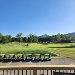 Panoramic view of a lush green golf course at The Jack Golf Course. Smooth