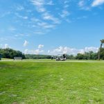 Panoramic view of a lush green golf course at The Legends at Parris Island Golf Course. Smooth