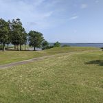Panoramic view of a lush green golf course at The Links At Land's End. Smooth