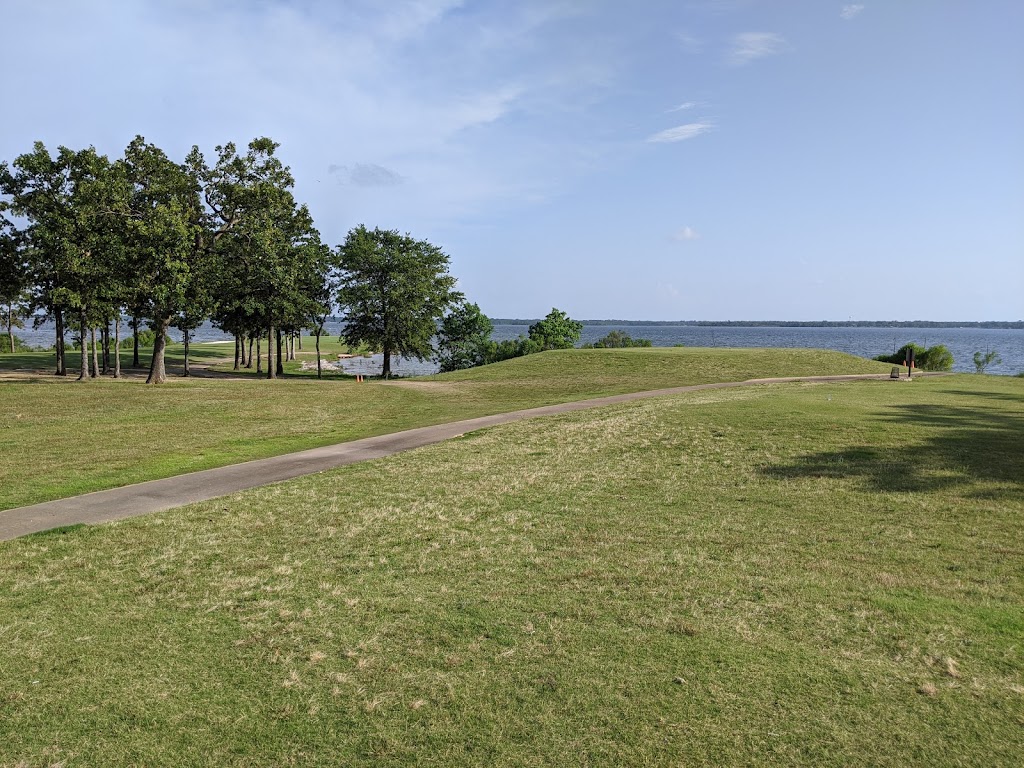 Panoramic view of a lush green golf course at The Links At Land's End. Smooth