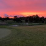 Panoramic view of a lush green golf course at The Links at Lang Farm. Smooth