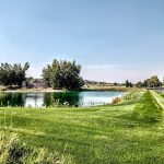 Panoramic view of a lush green golf course at The Links at Moses Pointe. Smooth