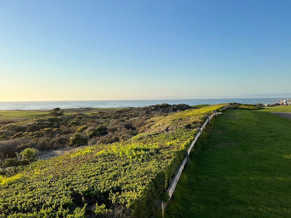 Panoramic view of a lush green golf course at The Links at Spanish Bay. Smooth