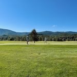 Panoramic view of a lush green golf course at The Lodge at The Greenbrier Sporting Club. Smooth