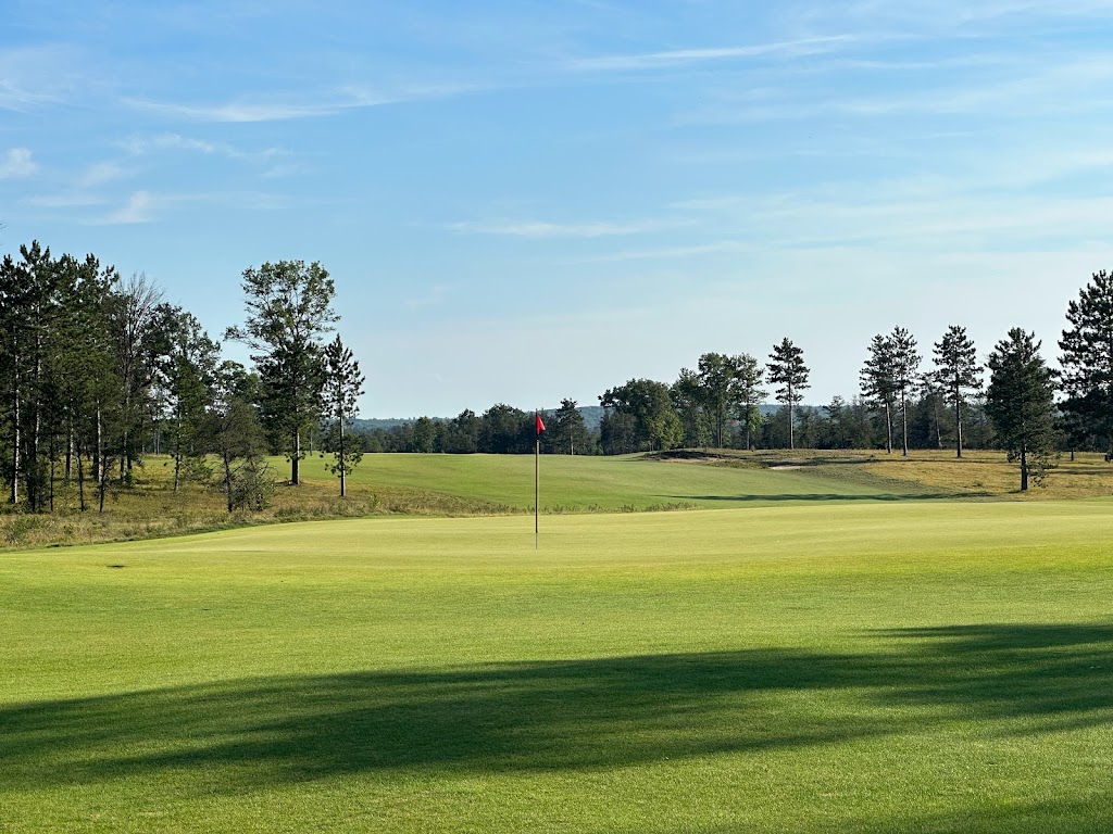 Panoramic view of a lush green golf course at The Loop. Smooth