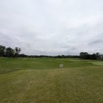 Panoramic view of a lush green golf course at The Loop at Chaska. Smooth