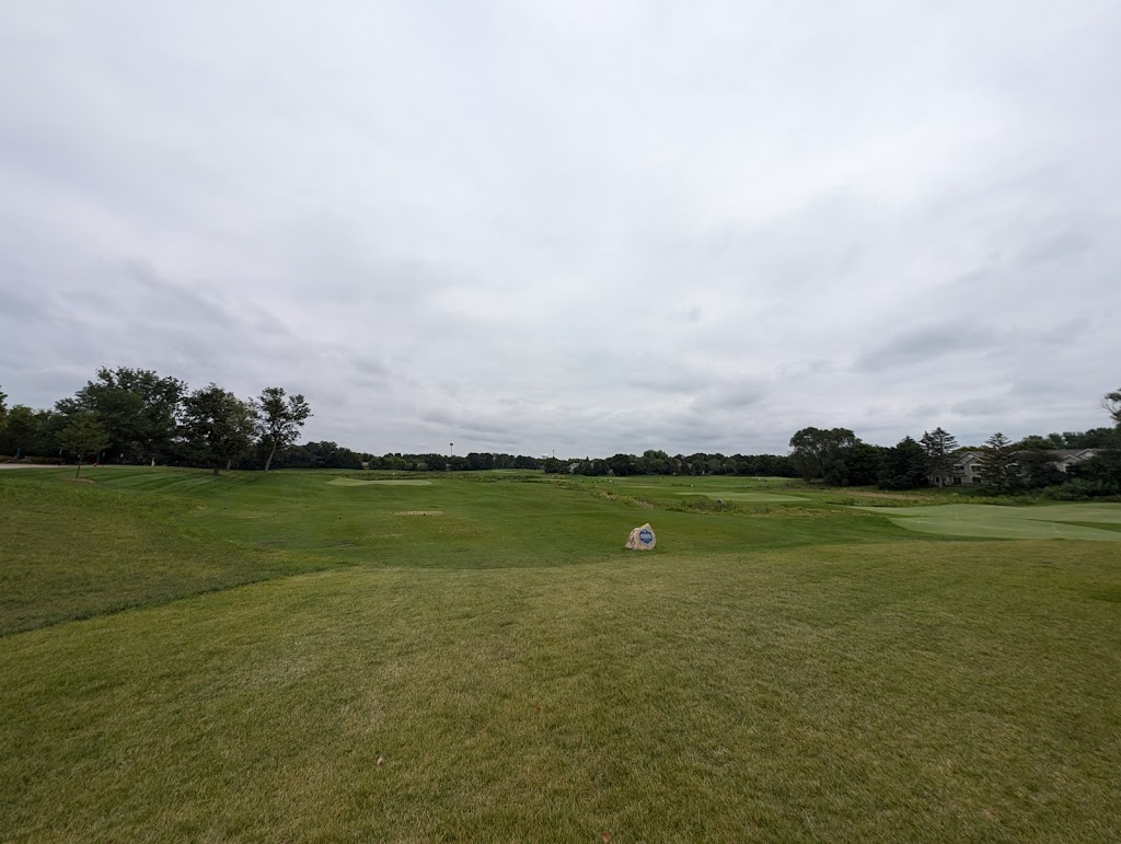 Panoramic view of a lush green golf course at The Loop at Chaska. Smooth