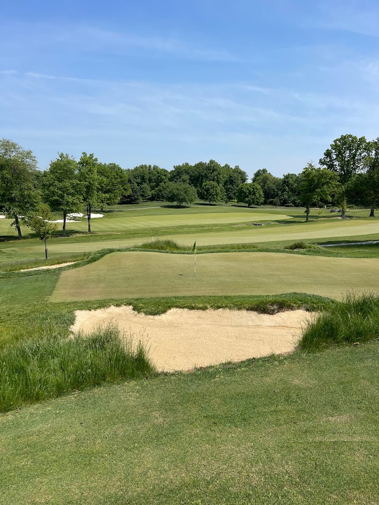 Panoramic view of a lush green golf course at The Loop. Smooth