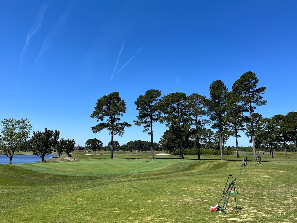 Panoramic view of a lush green golf course at The Man O' War Golf Club. Smooth
