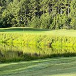 Panoramic view of a lush green golf course at The Manor Golf Club. Smooth