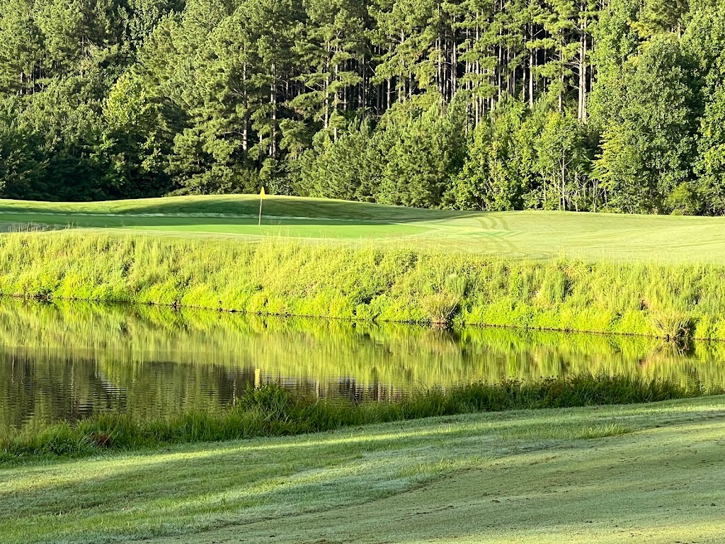 Panoramic view of a lush green golf course at The Manor Golf Club. Smooth