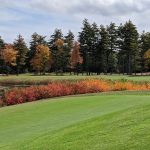 Panoramic view of a lush green golf course at The Oaks. Smooth