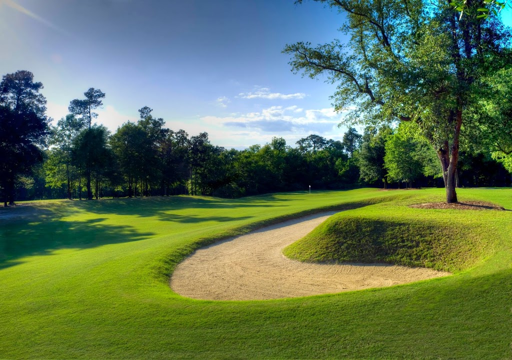Panoramic view of a lush green golf course at The Oaks Golf Club. Smooth