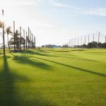 Panoramic view of a lush green golf course at The Park West Palm. Smooth
