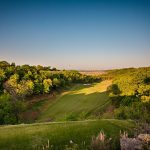 Panoramic view of a lush green golf course at The Patriot Golf Club. Smooth