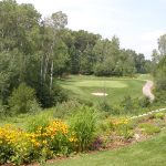 Panoramic view of a lush green golf course at The Patriot Golf Course. Smooth