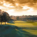Panoramic view of a lush green golf course at The Pearl Club. Smooth