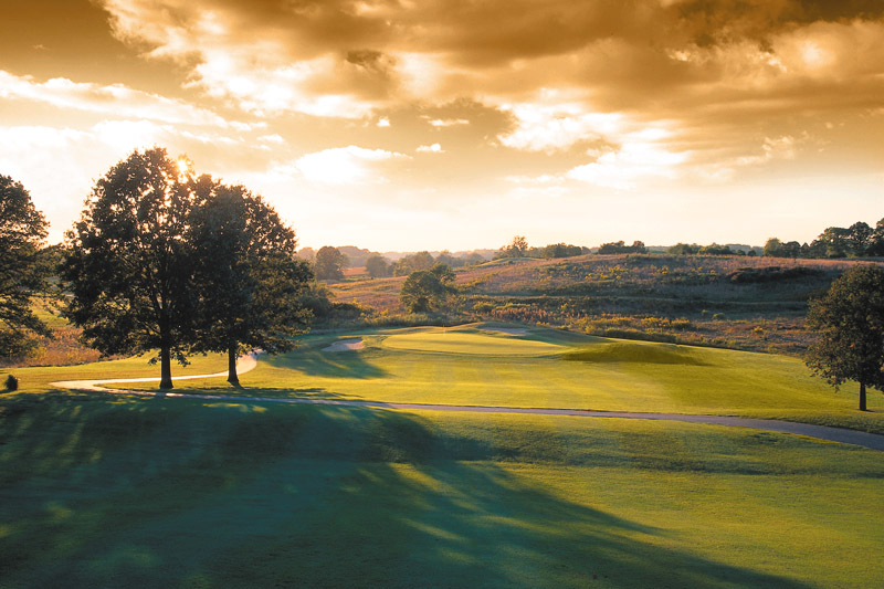 Panoramic view of a lush green golf course at The Pearl Club. Smooth