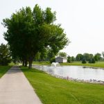 Panoramic view of a lush green golf course at The Pines Country Club. Smooth