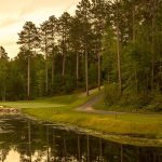 Panoramic view of a lush green golf course at The Pines Golf Course at Grand View Lodge. Smooth
