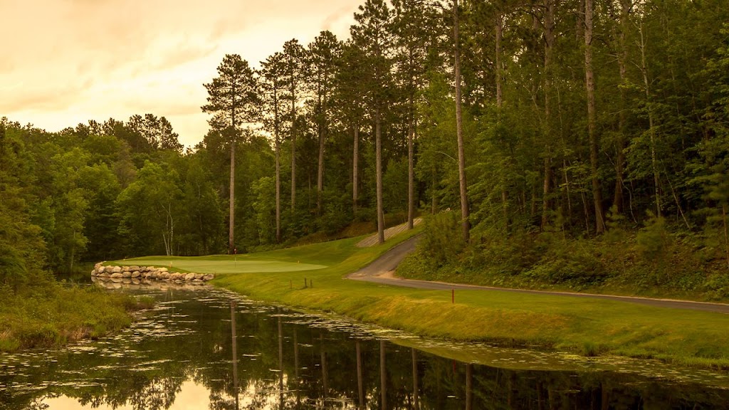 Panoramic view of a lush green golf course at The Pines Golf Course at Grand View Lodge. Smooth