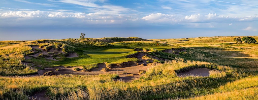 Panoramic view of a lush green golf course at The Prairie Club. Smooth