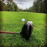 green grass with the flag in the hole.