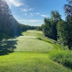 Panoramic view of a lush green golf course at The Quarry at Giants Ridge. Smooth