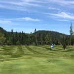 Panoramic view of a lush green golf course at The Ranch Club. Smooth