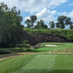 Panoramic view of a lush green golf course at The Ridge at Back Brook. Smooth