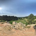 Panoramic view of a lush green golf course at The Ridge at Castle Pines North. Smooth