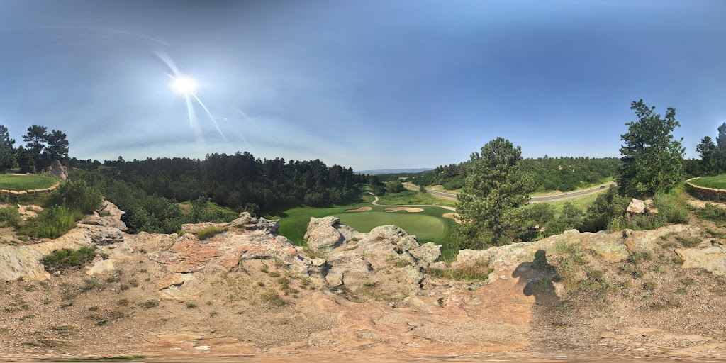 Panoramic view of a lush green golf course at The Ridge at Castle Pines North. Smooth