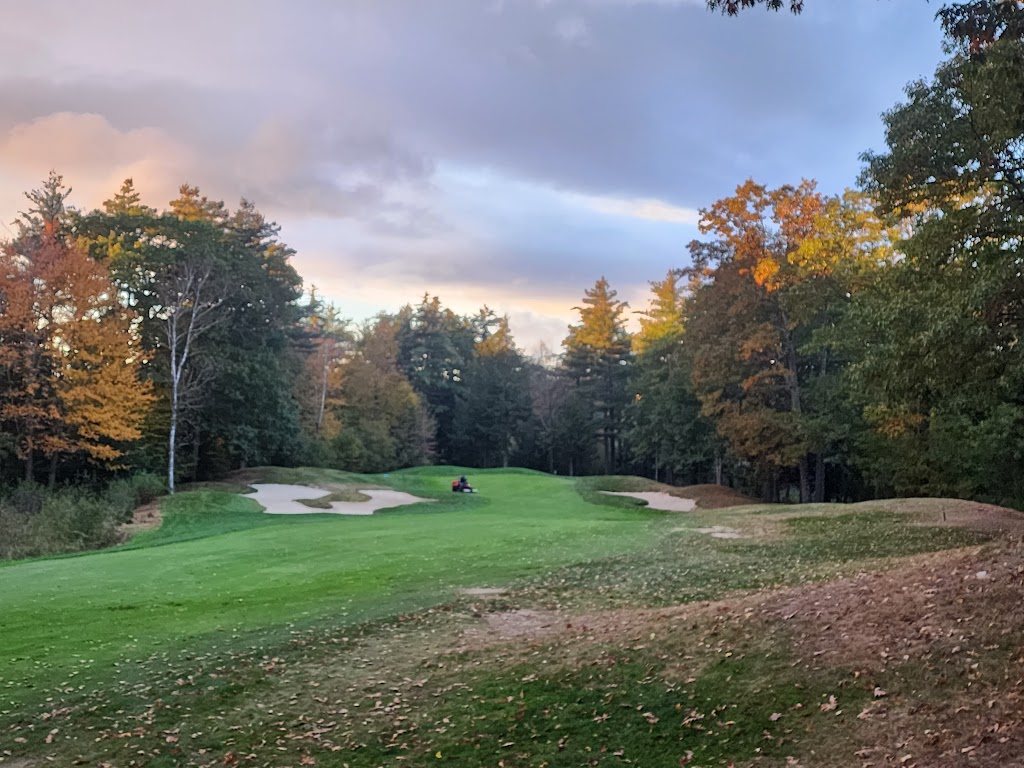 Panoramic view of a lush green golf course at The Shattuck Golf Club. Smooth