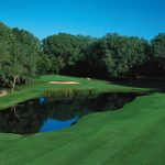 Panoramic view of a lush green golf course at The Trails Golf Club of Norman. Smooth