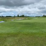 Panoramic view of a lush green golf course at The Trophy Club. Smooth