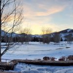 Panoramic view of a lush green golf course at The Valley Club. Smooth