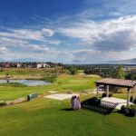 Panoramic view of a lush green golf course at The Vista at Cedar Hills Golf Club. Smooth