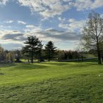 Panoramic view of a lush green golf course at The Woodford Club. Smooth