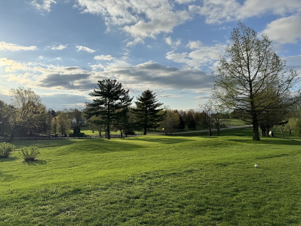 Panoramic view of a lush green golf course at The Woodford Club. Smooth