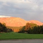 Panoramic view of a lush green golf course at Three Lakes Golf Course. Smooth