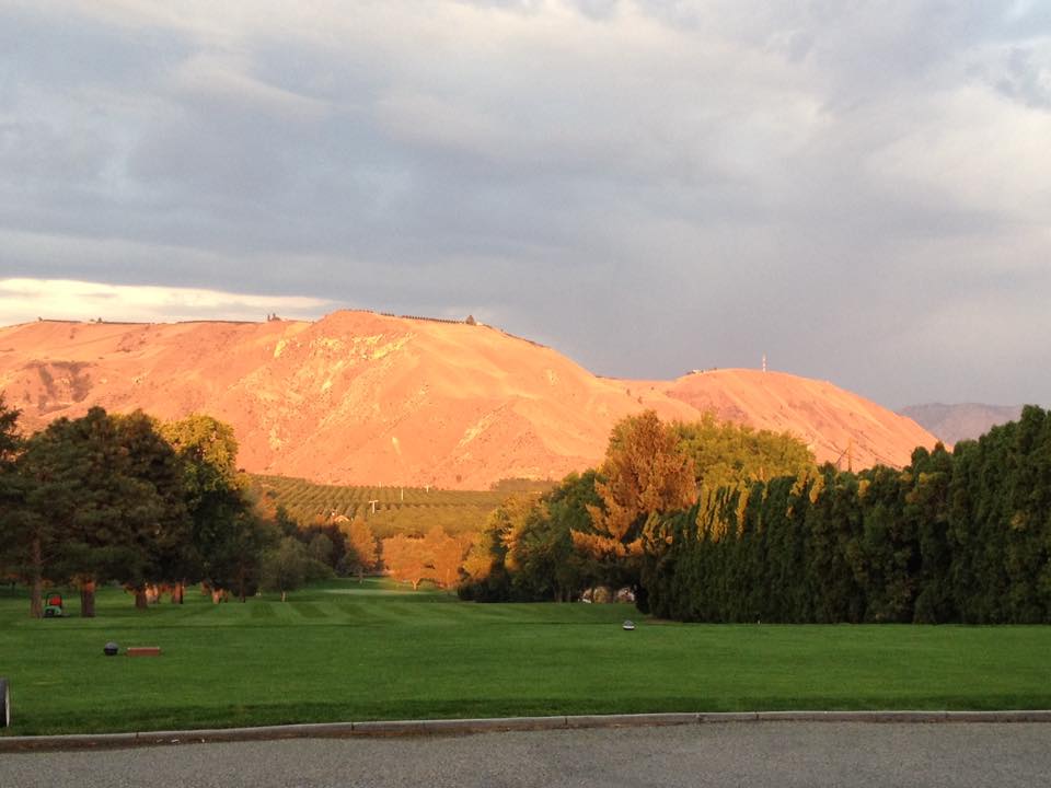 Panoramic view of a lush green golf course at Three Lakes Golf Course. Smooth