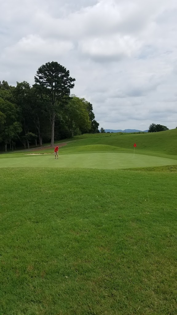 Panoramic view of a lush green golf course at Three Ridges Golf Course. Smooth