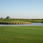 Panoramic view of a lush green golf course at Thunder Bayou Golf Links. Smooth