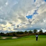 green grass with the flag in the hole.