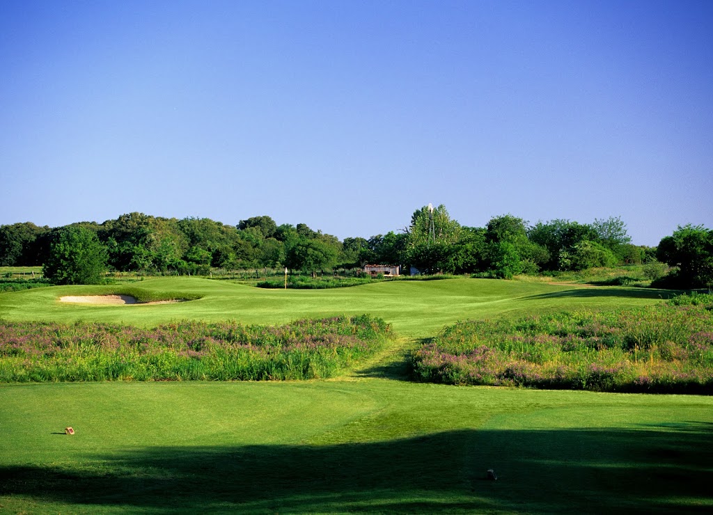 Panoramic view of a lush green golf course at Tierra Verde Golf Club. Smooth