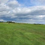 Panoramic view of a lush green golf course at Timber Point Golf Course. Smooth