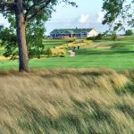 Panoramic view of a lush green golf course at Timber Pointe Golf Club. Smooth