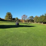 Panoramic view of a lush green golf course at Timberlin Golf Course. Smooth