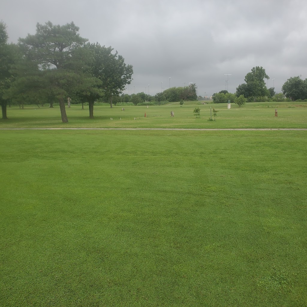 Panoramic view of a lush green golf course at Tinker Golf Course. Smooth